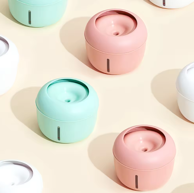 Pastel-colored pet fountains on a light background